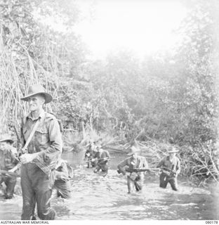 SIAR, NEW GUINEA. 1944-07-04. VX81112 LIEUTENANT G.H. ATKINSON, MC, 57/60TH INFANTRY BATTALION, 15TH INFANTRY BRIGADE (1), WITH SOME MEMBERS OF HIS ORIGINAL PLATOON TO ENTER MADANG. IDENTIFIED ..