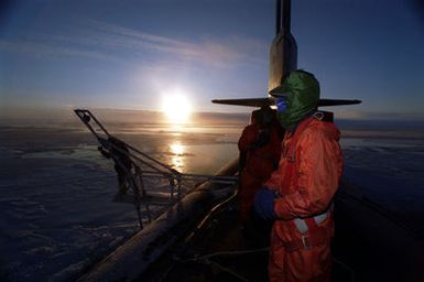 There is always room for a little humor, even in the harsh environment of the North Pole. Navy Sonar Technician First Class Mark Pierce greets everyones favorite holiday figure, Santa Claus. Santa was of course Sonar Technician First Class Robert Bissonnette. Both are crew members assigned to the U.S. Navys attack submarine USS POGY (SSN 647). The U.S. Navys attack submarine USS POGY (SSN 647) returned to Hawaii, on Tuesday, November 12, after a 45-day research mission to the North Pole. The second of five planned deployments through the year 2000, USS POGY embarked a team of researchers led by Mr. Ray Sambrotto of Columbia University. During the several thousand mile trek, the submarine...