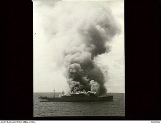 Smoke pours from the Italian motor vessel Romolo after being set on fire and scuttled by its crew after being pursued from Brisbane by the Armed Merchant Cruiser HMAS Manoora and finally ..