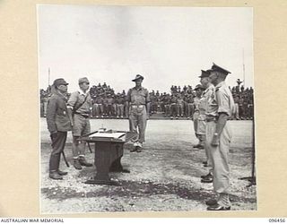 CAPE WOM, NEW GUINEA, 1945-09-13. LIEUTENANT-GENERAL H. ADACHI, COMMANDER 18 JAPANESE ARMY IN NEW GUINEA STANDING FACING MAJOR-GENERAL H.C.H. ROBERTSON, GENERAL OFFICER COMMANDING 6 DIVISION, WITH ..