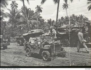 AITAPE, NORTH EAST NEW GUINEA. 1944-04-22. RAAF ENGINEERS DRIVE IN A JEEP TO THE BIVOUAC AREA AFTER GETTING GEAR OFF LANDING CRAFT AT AITAPE