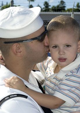 U.S. Navy Fire Controlman 1ST Class Kris McGuire kisses his son goodbye as he prepares to depart aboard the Arleigh-Burke Class Guided-Missile Destroyers USS O'KANE (DDG 77) on Jan. 26, 2007, at Pearl Harbor, Hawaii. (U.S. Navy photo by Mass Communication SPECIALIST 2nd Class Lindsay J. Switzer) (Released)