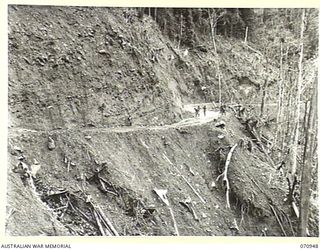 WAU - LAE ROAD, NEW GUINEA, 1944-02-27. ROAD MAINTENANCE ON A SECTION OF THE ROAD APPROXIMATELY 50 MILES FROM WAU