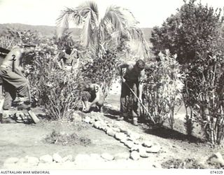 BULOLO, NEW GUINEA. 1944-07. PERSONNEL OF THE AUSTRALIAN FIELD SECURITY SECTION ATTACHED TO HADQUARTERS, 11TH DIVISION, WORKING IN THE GARDENS SURROUNDING THEIR TENTS. IDENTIFIED PERSONNEL ARE:- ..