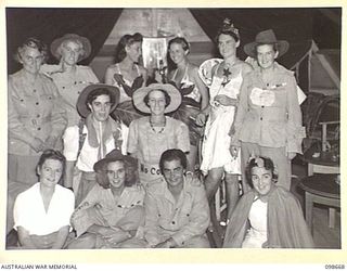 LAE, NEW GUINEA. 1945-11-08. A GROUP OF AUSTRALIAN WOMEN'S ARMY SERVICE OFFICERS IN FANCY DRESS, AT THE FANCY DRESS PARTY HELD BY MEMBERS OF BARRACKS TO FAREWELL CAPTAIN M.W. HORNSBY AND CAPTAIN ..