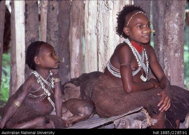 Girls relaxing on the sleeping/ sitting platform in Bulong longhouse