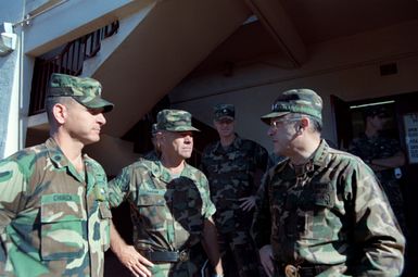 GEN Robert W. Riscassi, right, Vice CHIEF of STAFF, U.S. Army, BGEN Craig Hagan, Assistant Division Commander, 25th Infantry Division (Light) talk with two of the division's officers during Riscassi's visit to the base