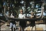 Frances Harwood with two men and miniature canoe