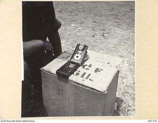 CAPE PUS, NEW GUINEA. 1945-09-29. PICTURE OF THE HIGHEST JAPANESE DECORATION FOR BRAVERY FOUND AMONGST JAPANESE GEAR BY CORPORAL J.A. YATES, 2/3 INFANTRY BATTALION. THE MEN INTEND RAFFLING THE ..