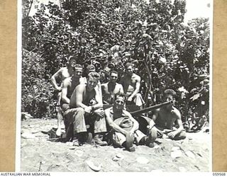 FINSCHHAFEN AREA, NEW GUINEA, 1943-10-23. GROUP PORTRAIT OF MEMBERS OF HEADQUARTERS COMPANY, 532ND UNITED STATES ENGINEERS BOAT AND SHORE REGIMENT WITH THEIR 37MM ANTI-TANK GUN WHICH HELPED KNOCK ..