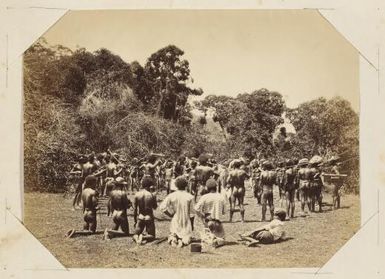 Kanak men performing a ceremony involving weapons, New Caledonia, ca. 1870s / Allan Hughan