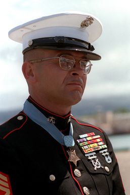 Marine Sergeant Major Allan J. Kellogg, right, Medal of Honor recipient for duty in Vietnam, attends a ceremony to honor the Unknown Serviceman of the Vietnam Era. The serviceman's casket will be transported to California aboard the frigate USS BREWTON (FF 1086) and then transferred to Arlington National Cemetery for interment at the Tomb of the Unknowns