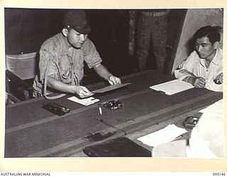 TOKO, BOUGAINVILLE, 1945-08-18. MAJOR OTSU (1), MEMBER OF A SURRENDER ENVOY FROM LIEUTENANT-GENERAL M. KANDA, COMMANDER IMPERIAL JAPANESE 17 ARMY GROUP, AT HEADQUARTERS 3 DIVISION, WITH AN ENVELOPE ..