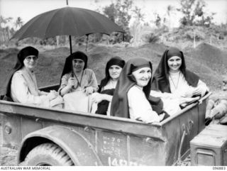 Vunapope, New Britain. Five nuns seated in a jeep trailer during their evacuation from the Mission in Ramale Valley to Rabaul. Contact with the internees was made by Allied troops and ..