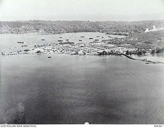 LOS NEGROS, ADMIRALTY ISLANDS. 1944-10-19. AERIAL VIEW OF THE AMERICAN SEAPLANE BASE. COMPARISON WITH NEGATIVE NO 304171 WILL SHOW THE IMPROVEMENTS MADE AFTER SIX MONTHS WITH ROADS, RAMPS AND ..