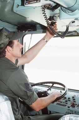 Technical Sergeant Albert Stanford, 137th Combat Support Squadron, Oklahoma Air National Guard, makes an adjustment in the controls of fire fighting equipment