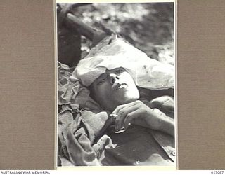 PAPUA, NEW GUINEA. 1942-10. A JAPANESE BEING CARED FOR AFTER HE HAD BEEN BROUGHT IN FROM THE HILLY COUNTRY NEAR EORIBAIWA. HE WAS UNABLE TO STAND, BEING VERY WEAK AND EMACIATED