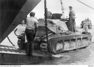 TOROKINA BEACHHEAD, BOUGAINVILLE, 1945-03-30. A MATILDA TANK OF B SQUADRON 2/4TH ARMOURED  REGIMENT MOVING INTO AN AMERICAN LANDING CRAFT TRANSPORT TO BE TAKEN TO TOKO