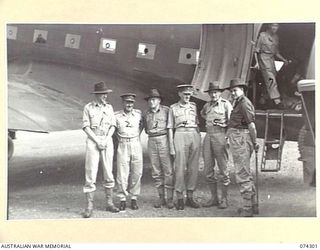 LAE, NEW GUINEA. 1944-07-02. MEMBERS OF THE EMPIRE PARLIAMENTARY ASSOCIATION STANDING ALONGSIDE THE RAAF DOUGLAS C47 DAKOTA AIRCRAFT WHICH BROUGHT THEM TO NEW GUINEA. IDENTIFIED PERSONNEL ARE:- MR. ..