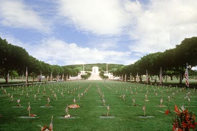 A view of the flag adorned veteran's graves in the National Memorial Cemetery of the Pacific in the "Punch Bowl", Honolulu, Hawaii. Exact Date Shot Unknown