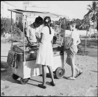 Street vendor with customers, Fiji, 1966 / Michael Terry