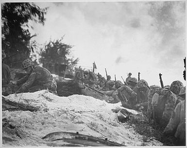 "Negro assault troops await orders D-day to attack enemy shortly after they had come ashore at Saipan in the Marianas."