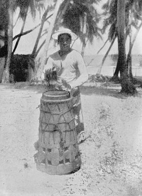 Man playing a village drum for dancing, Manihiki, Cook Islands