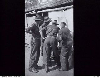 NEW GUINEA. 1943-08-20. OUTSIDE THE ELECTION POLLING BOOTH AT HEADQUARTERS, 21ST AUSTRALIAN INFANTRY BRIGADE. SERGEANT SHANNON FAR LEFT