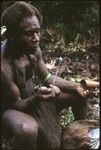 Man eating from a tube