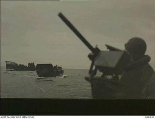 New Britain. 15 December 1943. Gunners stand to their posts as the American landing barges approach the coral shores near Arawe in one of the most daring amphibious assaults yet undertaken in this ..