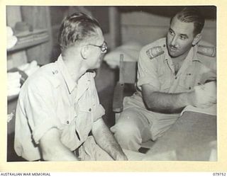 TOROKINA, BOUGAINVILLE, SOLOMON ISLANDS. 1945-03-14. NX234 CHAPLAIN F.O. HULME-MOIR, SENIOR CHAPLAIN, (CHURCH OF ENGLAND), 2ND AUSTRALIAN CORPS (2), ADVISING ONE OF THE MEMBERS OF THAT FORMATION, ..