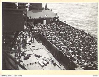 OFF BORAM BEACH, NEW GUINEA. 1945-10-13. THE FIRST BATCH OF TROOPS TO LEAVE THE WEWAK AREA UNDER THE PRIORITY DEMOBILISATION SCHEME WERE MEMBERS OF 6 DIVISION. SHOWN, VIEW LOOKING DOWN FROM HMAS ..