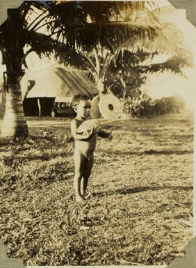 Child holding a coconut, 1928