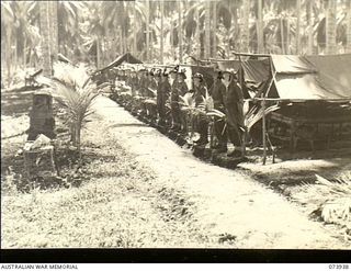 MADANG, NEW GUINEA. 1944-06-14. TROOPS OF NO. 13 PLATOON, C COMPANY, 58/59TH INFANTRY BATTALION LINED UP OUTSIDE THEIR TENTS DURING AN INSPECTION. THE UNIT IS LOCATED AT SIAR PLANTATION. RIGHT TO ..