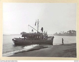 BOUGAINVILLE. 1945-05-25. THE ARMY TUG AT 1503, 42 LANDING CRAFT COMPANY, AFTER IT HAD BEEN BLOWN ON THE BEACH BY A SUDDEN CYCLONE