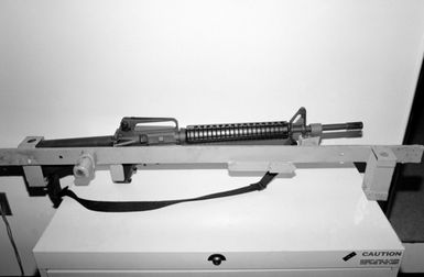 A locking storage rack aboard the amphibious assault ship USS SAIPAN (LHA 2) that has been modified to accept the M249 squad automatic weapon (SAW) (shown in rack) and the M16A2 rifle