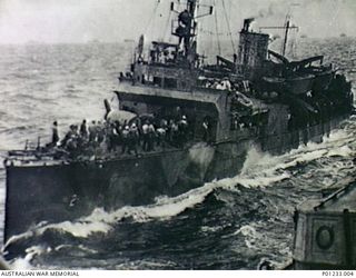 Off Tulagi, the Wickes-class destroyer USS Colhoun (DD-85 later APD-2) transports 1st Marine Raider Battalion troops to participate in the invasion of the Solomon Islands