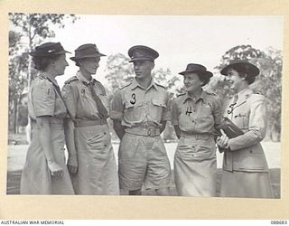 BRISBANE, QUEENSLAND. 1945-02-19. LIEUTENANT-COLONEL E.K. FISK, (3), IN DISCUSSION WITH COLONEL S.H. IRVING, CONTROLLER AUSTRALIAN WOMEN'S ARMY SERVICE, (2), AND SENIOR OFFICERS DURING HER VISIT TO ..