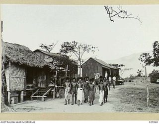 PORT MORESBY, PAPUA. 1942-07. A GROUP OF NEW GUINEA "BOYS" IN A NATIVE VILLAGE SINCE THE DEPARTURE OF THE WHITE CIVILIAN POPULATION THESE "BOYS" DO LAUNDRY WORK AND DOMESTIC DUTIES IN CAMP AREAS