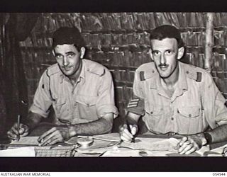 MILNE BAY, NEW GUINEA, 1943-07-12. QX25175 WARRANT OFFICER 2 A. R. S. FRASER, REGIMENTAL SERGEANT MAJOR (LEFT) AND Q45487 SERGEANT K. E. COLLOM, PAY SERGEANT, BOTH OF THE 5TH AUSTRALIAN DIVISION AT ..