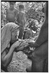 Bride price for Mitsi: women from the bride's group are fed pork provided by the groom's group