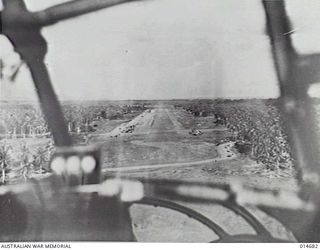 MILNE BAY, NEW GUINEA, C. 1945. VIEW FROM THE COCKPIT OF A BEAUFORT BOMBER OF THE AIRSTRIP DURING A PRACTICE RUN. (PHOTOGRAPHER: N. BROWN)