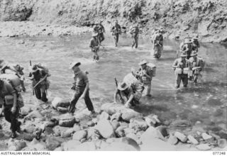 DOYABIE AREA, BOUGAINVILLE ISLAND. 1944-11-23. TROOPS OF THE 9TH INFANTRY BATTALION FORDING THE LARUMA RIVER AT THE END OF THE NUMA NUMA TRAIL AS THEY MOVE FORWARD TO TAKE OVER POSITIONS OCCUPIED ..