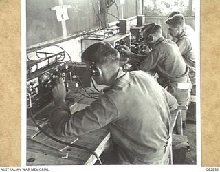 DUMPU, NEW GUINEA. 1944-01-11. THE CENTRAL WIRELESS TELEPHONE RECEIVING HUT OF THE 7TH DIVISION SIGNALS, SHOWING THE ARRANGEMENT OF THE NO. 4 AUSTRALIAN RECEIVERS