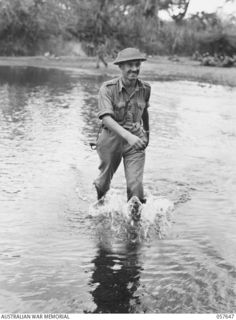 MARINGGUSIN, NEW GUINEA, 1943-09-29. VX35 LIEUTENANT COLONEL J.A. BISHOP, DSO, MBE, COMMANDING OFFICER, 2/27TH AUSTRALIAN INFANTRY BATTALION CROSSING THE YATI RIVER