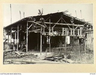 ALEXISHAFEN, NEW GUINEA. 1944-05. MEMBERS OF THE 2/15TH FIELD AMBULANCE BUILDING A NEW WARD AT THE OLD CATHOLIC MISSION, THE PRESENT CAMP SITE OF THE UNIT. MANY OF THE MISSION BUILDINGS HAVE BEEN ..