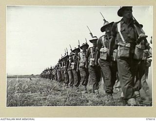 WAWIN, MARKHAM VALLEY, NEW GUINEA. 1944-10-24. TROOPS OF THE ROYAL AUSTRALIAN ARTILLERY SECTIONS OF THE 3RD DIVISION GIVE EYES RIGHT TO NX4 BRIGADIER B.E. KLEIN, COMMANDER ROYAL ARTILLERY, 3RD ..