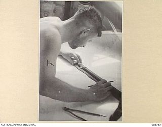 MADANG, NEW GUINEA. 1944-11-06. SUB- LIEUTENANT A KEOGH AT THE CHART TABLE ABOARD HMAS STAWELL