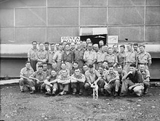 LAE AREA, NEW GUINEA. 1945-08-31. THE STAFF OF THE ARMY NEWSPAPER, GUINEA GOLD, WHICH IS EDITED AND PRINTED AT "CHARING CROSS" IN THE LAE BASE