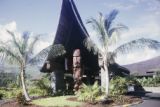 French Polynesia, wood carving at entrance to building on Tahiti Island